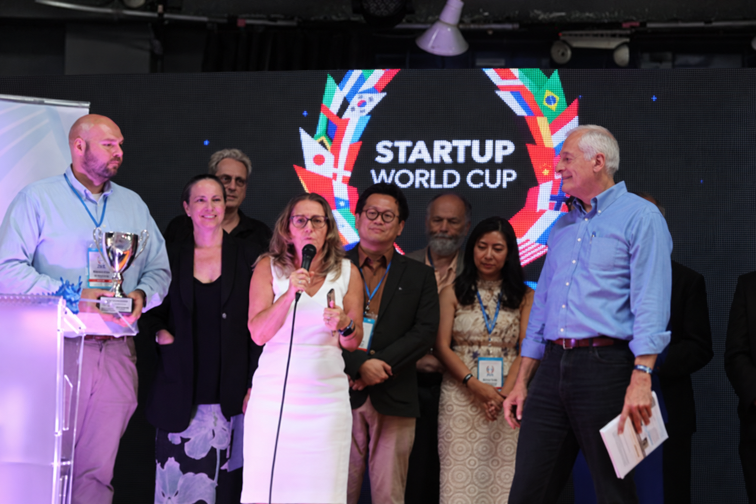Dr. Ioana Cozmuta of G-SPACE accepting the Startup World Cup Santa Cruz Regional championship on stage at The Catalyst